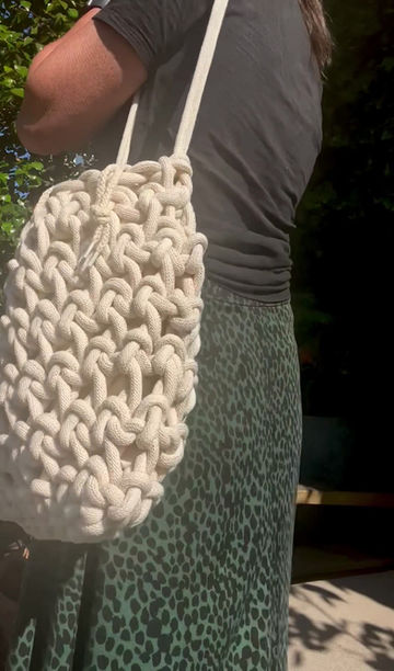 Thumbnail: video of lady wearing off white crochet shoulder summer eco-friendly bag