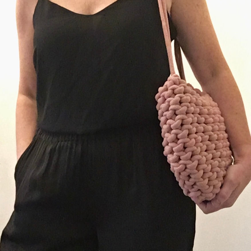 Thumbnail: person wearing blush pink shoulder bag in knotted cotton cord