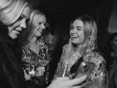 Friends talking and laughing together at a birthday parti in Stockholm. Event planner Stockholm