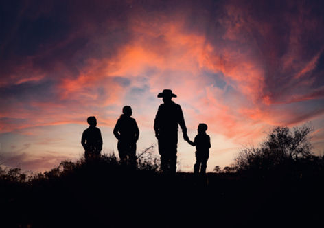 Family silhouettes at sunset