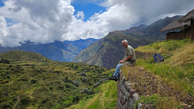 Nigel sitting on the edge of one of the many terraces of Huchuy Qosco