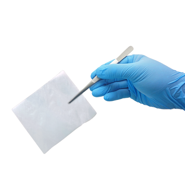 Gloved Hand Holding Eliksa Amniotic Membrane Dehydrated.png