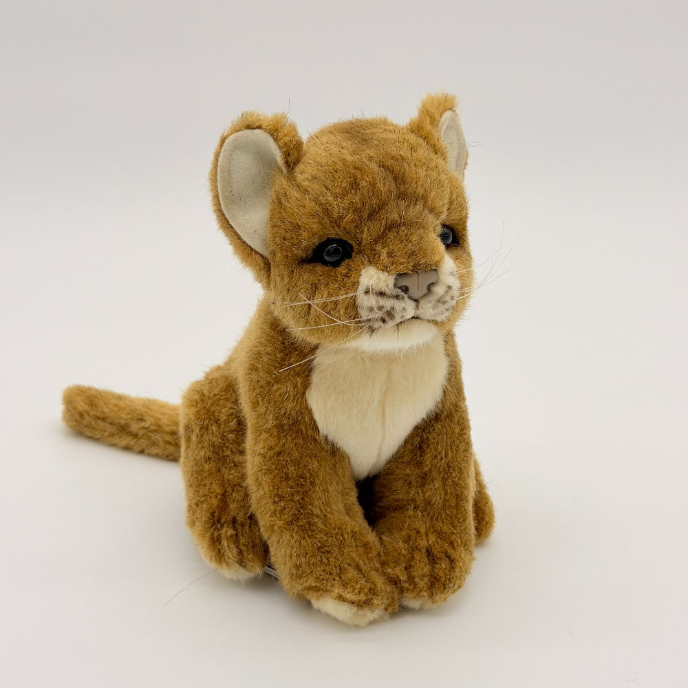 Front view 18cm handcrafted lion cub by Hansa. Features soft brown fur, white inner ears and chest and black bead eyes.
