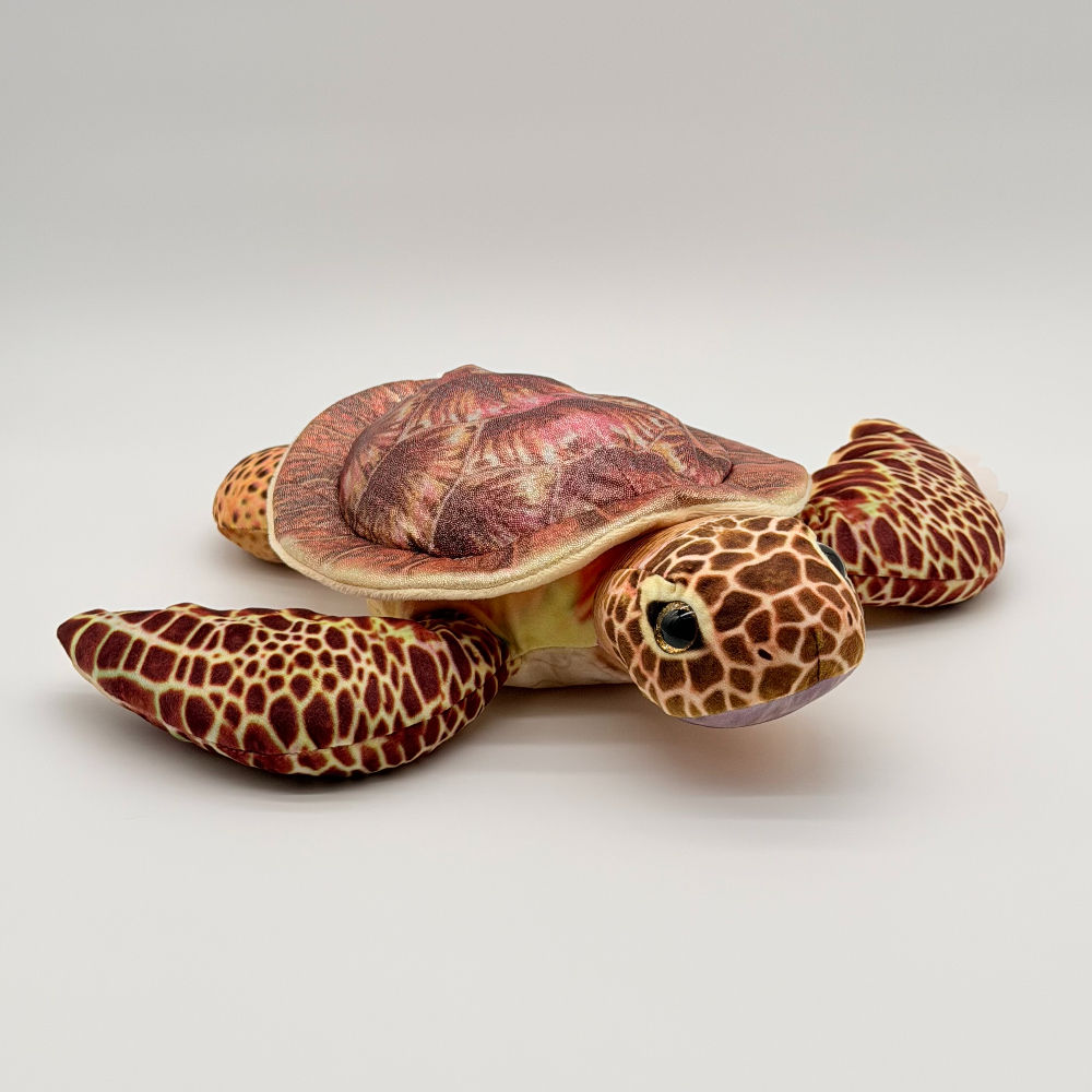 Front view Huggable Toys turtle with glittery top shell, cream under-shell, and delightfully scaly, texturized flippers
