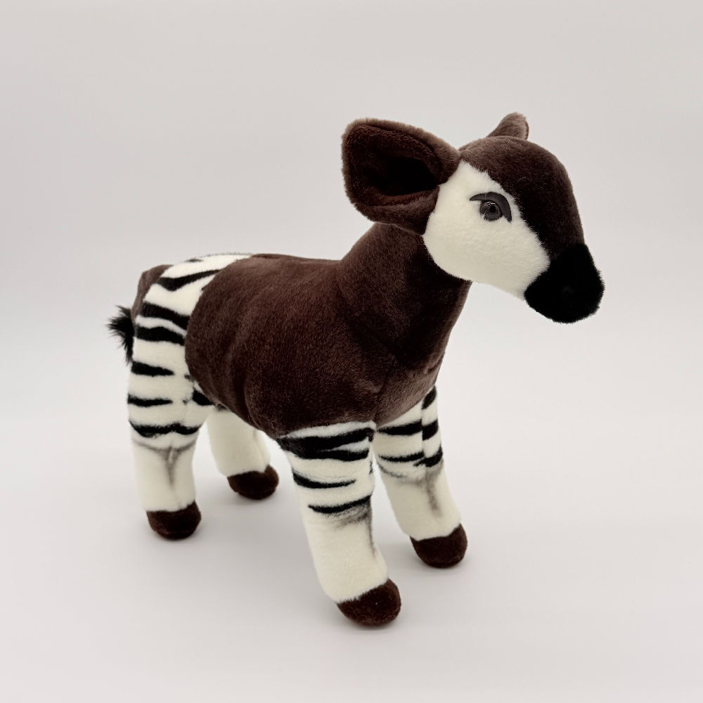 Front view Living Nature 33cm Okapi plush toy with soft brown fur, striped rump and legs, white and brown face, black nose