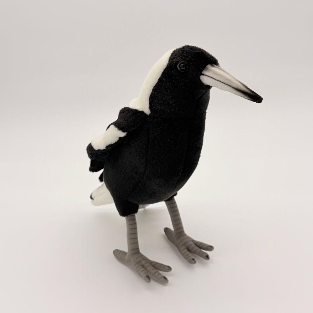 Front view Hansa 26cm hand-crafted magpie. Fur features black underbelly and black and white wings