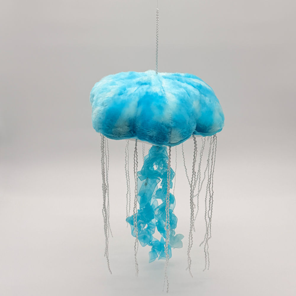 Front view Huggable Toys 30cm Jellyfish plush toy with soft turquoise bell shaped with flowing ribbon like tentacles.