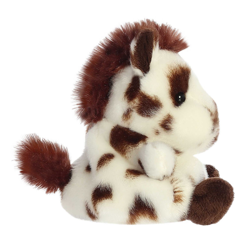 Side view Palm Pals 13cm Haymitch the Painted horse plush toy. Soft white body, bold brown patches, a brown mane and tail.