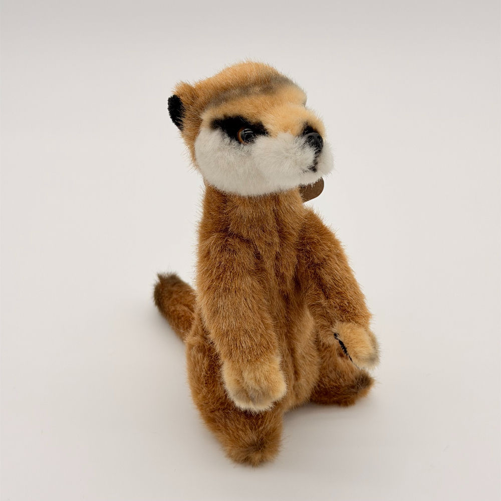 Front view Lil Friends Meerkat plush toy with soft light brown fur, white cheeks and jaw, large black eyes and black nose