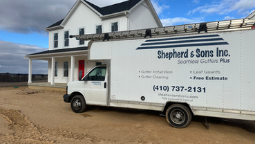 shepherd & sons inc. installing gutters on white farmhouse in westminster for castlerock builders