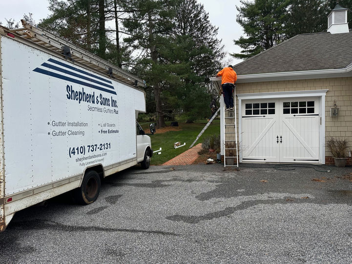 gutters being installed on home with shepherd & sons truck in the driveway