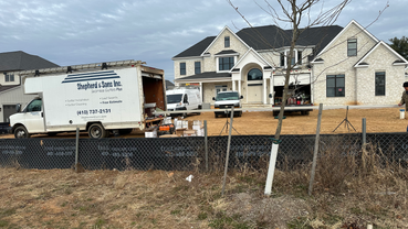 Shepherd & Sons Inc. installing white 5 inch gutters on home in Laurel MD for Williamsburg homes