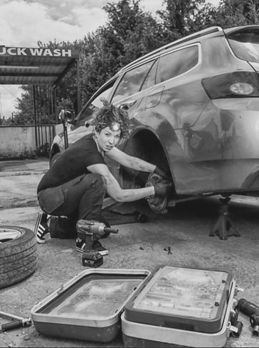 Female Mechanic Fixing a Car