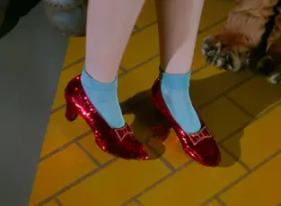 Sequined red shoes on the feet of a woman in a 