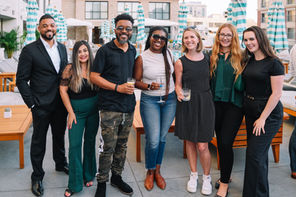 Group on patio: Group of members posing together at a The Network San Diego rooftop mixer event