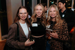 Three professional women: Smiling attendees with nametags at a The Network San Diego evening mixer