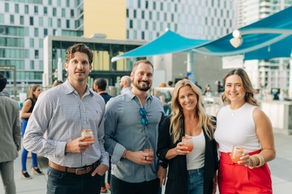 Downtown rooftop: Professionals networking on a downtown San Diego rooftop with city views overlooking waterfront