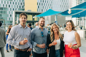 Downtown rooftop: Professionals networking on a downtown San Diego rooftop with city views overlooking waterfront