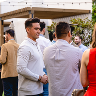 Patio conversation: Two professionals in conversation at an outdoor networking mixer in San Diego