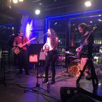Gabrielle and their band perform at Sauf Haus. Anthony is playing bass and Levi is playing guitar.