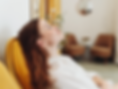 Woman sitting in chair relaxing during hypnosis. Hypnotherapy near me. Hypnosis online.