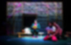 Four actors on stage, one sitting and reading, two in shock. Backdrop text: "STOP THE CLAUSE." Vibrant colors, dramatic mood.