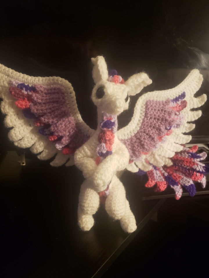 Eye-level view of colorful crochet scarves and handmade jewelry display