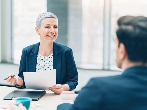 Woman-across-table-interviewing-man