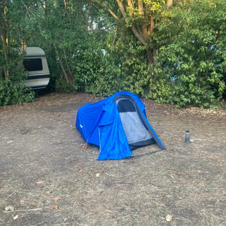 My tent set up in a large grassy plot