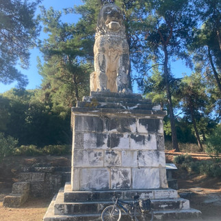 A big statue of a lion with my bicycle below