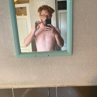 Scruffy me brushing my teeth in a mirror