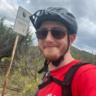 Me happy in front of a sign for Bosnia