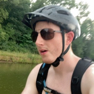 A man cycling shirtless