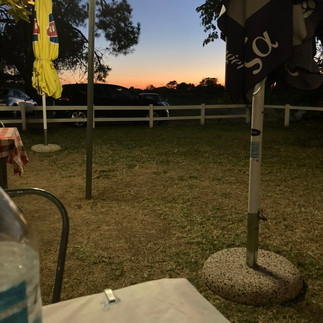 Sunset behind a mosquito ridden light pole