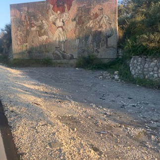 An Albanian communist mural with dusk lighting