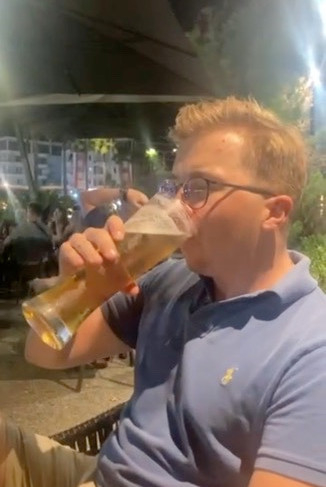A belgian man drinking an Albanian beer