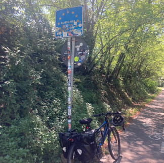 A bike leaning on a sign that says Slovenia