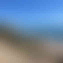 Boulders and cliffs by the blue sea