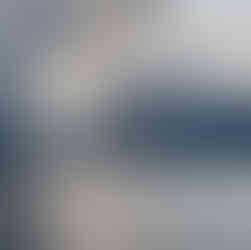 Sun streaming through clouds above a lake