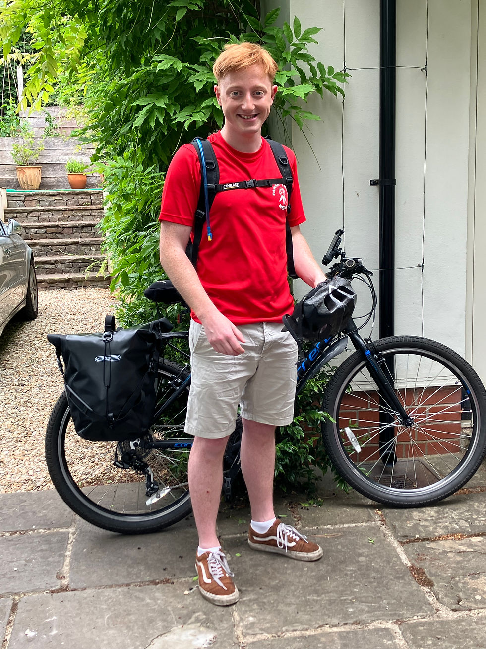 Me in a red shirt by a laden bicycle.