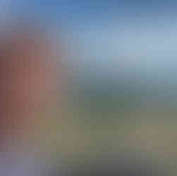 Me in front of a rocky Croatian vista with wooded hills behind