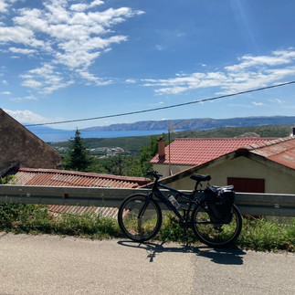 A bike in front of a croatian roof and the sea