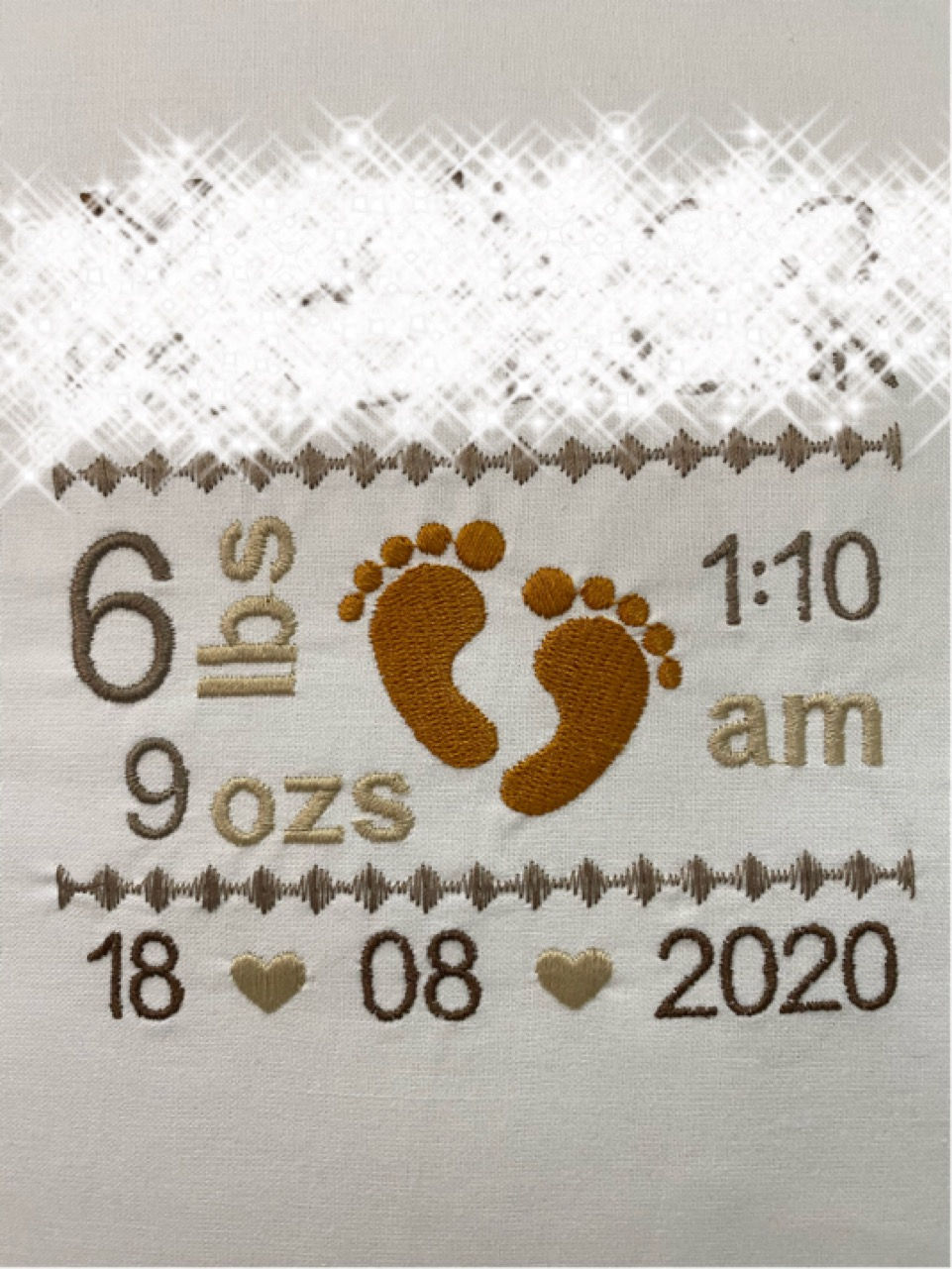 Thumbnail: close up of beige birth announcement cushion