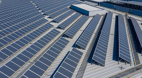 Industrial rooftop solar panels installed on a large commercial building