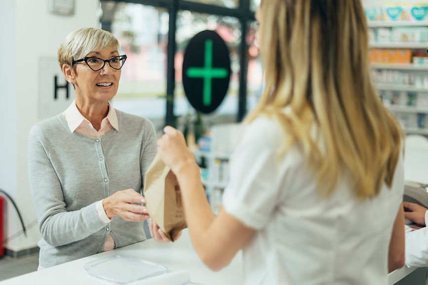 woman-receives-prescription-from-pharmacist-at-pha-2026-03-25-06-36-10-utc (1).jpg