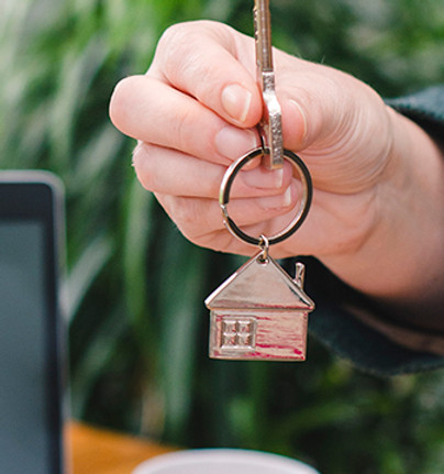 Home move specialist, holding up a key to your new home