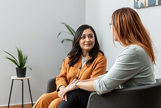 female psychotherapist sitting with clie