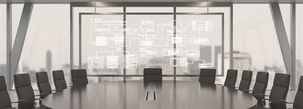 Whiteboard displaying web user-interface wireframing in front of an empty boardroom.