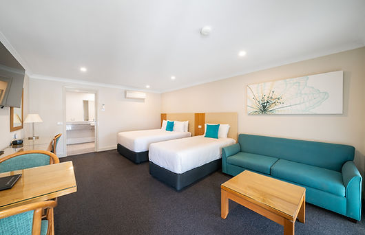 a photo of our executive twin room with a queen bed and a single and a lounge