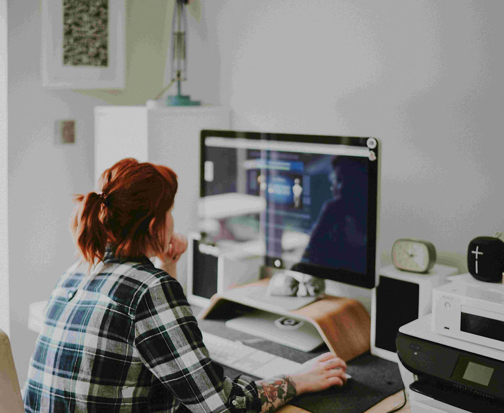 A female Virtual Assistant designs a graphic design image for a client.